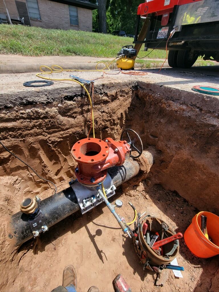 A completed valve installation on a service line in an open trench